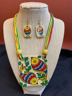 a necklace and earring set on a mannequin