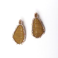 Gold Earrings - These mixed-media earrings are crafted from hand-embroidered cotton thread in a sterling silver frame and feature suede and a pierced, patinated brass background. Lightweight yet visually substantial, they hang from sterling silver ear posts. Brass Background, Embroidered Earrings, Artful Home, Textile Jewelry, Embroidery Jewelry, Christmas Earrings, Silver Frame, Cotton Thread, Earings Piercings