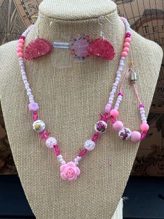 This beautiful pink beaded necklace set is perfect for adding a touch of girly glam to any outfit. The set includes a long necklace with a variety of pink beads, including pink glass beads, pink acrylic beads, and pink seed beads. A sparkling pink star charm and a delicate rose charm add a touch of whimsy to the design. The necklace is finished with a lobster clasp closure. The set also includes a shorter necklace with pink beads and a magnetic clasp closure. Adjustable Pink Beaded Jewelry, Pink Party Necklace With Heart Beads, Pink Heart Beads Necklace For Party, Pink Beaded Jewelry For Gift, Pink Necklace With Heart Beads For Party, Pink Heart Beads For Jewelry Making, Adjustable Single Strand Pink Beaded Necklace, Pink Heart Beads Jewelry For Party, Pink Beaded Chain Jewelry For Gift