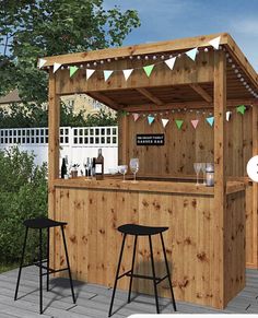 an outdoor bar with two stools next to it