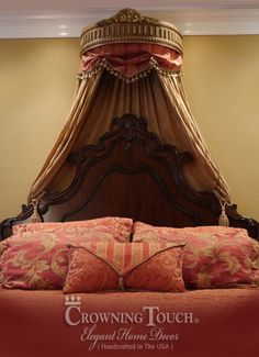 the canopy bed is made up with red and gold sheets, pillows, and throw pillows