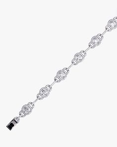 - Halo and Link Bracelet with sterling silver- Made in Sterling silver set with a high-quality Cubic Zirconia. - Stone size: 4.00 mm, 1.10 mm- Length: 7 inch Sterling silver925 Sterling Silver is an alloy made of 92.5% pure silver and 7.5% copper. We plate our silver jewelry in rhodium, which gives it extra shine and durability. Rhodium is one of the costliest precious metals due to its rarity.CareH2O sensitive. Avoid water when wearing your piece, because over time the sterling silver will oxid Silver Fine Jewelry Chain Bracelet With Diamond Accents, Sterling Silver Tennis Bracelet With Diamond Accents, Fine Jewelry Diamond Chain Bracelet In Silver, Fine Jewelry Silver Chain Diamond Bracelet, White Gold Sterling Silver Chain Bracelet With Diamond Accents, Fine Jewelry Silver Diamond Chain Bracelet, Sterling Silver Diamond Cut Tennis Bracelet, Sterling Silver Cubic Zirconia Bracelet For Anniversary, Silver Cubic Zirconia Crystal Bracelet Fine Jewelry