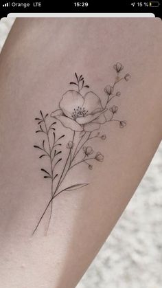 a tattoo with flowers on the arm