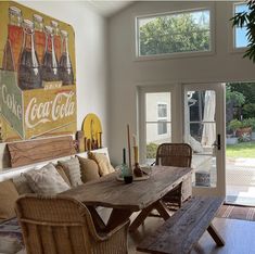 a living room filled with furniture and a large painting on the wall next to a sliding glass door