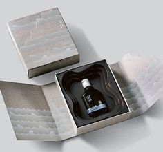 an open box with a bottle inside it