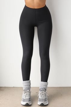 Slimming full length high-rise legging with an elastic waistband. Body contouring fabric that feels like a second skin Super soft and stretchy Hugs curves for a sleek and sculpted look Designed to retain its shape all day long, wear after wear Color: Sueded Onyx Sizing: X/S (0-4), S/M (4-8), M/L (8-10) Model is 5'8" and wearing size X/S Fabric: 76% Polyester, 24% Spandex Care: Machine Wash Cold With Like Colors. Care: Lay Flat to Dry. JOAH BROWN | MADE IN LOS ANGELES Winter Sports Leggings Made Of Elastane, Compression Leggings With Contoured Waistband, Tight Athleisure Leggings With Wide Waistband, Tight Full-length Leggings With Wide Waistband, Full Length Tight Leggings With Wide Waistband, High Stretch Smoothing Activewear With High-cut Leg, Tight Leggings With Contoured Waistband For Pilates, High Stretch Elastane Leggings With Elastic Waistband, Athleisure Tights With Tight Fit And Wide Waistband