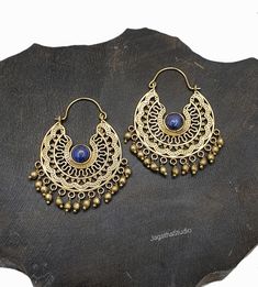 HANDMADE Beautiful Mandala hoop earrings with gemstones.l dangle details. Ideal for a special bohemian look. SIZE Aprox Length: 5.4 cm Aprox diameter: 3.5 cm Handmade with high quality hypoallergenic Jewelery brass, nickel free. LINK Please follow the link to view my shop for other beautiful pieces. https://www.etsy.com/uk/shop/JagathaStudio Bohemian Brass Jewelry For Rituals, Nickel-free Dangle Hoop Earrings For Festive Occasions, Festive Nickel-free Dangle Hoop Earrings, Bohemian Teardrop Brass Hoop Earrings, Festive Brass Dangle Hoop Earrings, Blue Bohemian Earrings For Festival, Bronze Festival Earrings, Blue Festival Earrings With Latkans, Intricate Design Jewelry For Festival