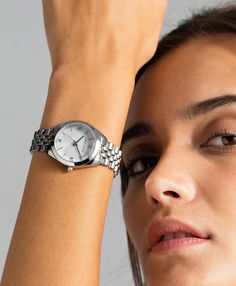 A classic design, elevated. The bold and urban Vivid watch features a statement round face with chunky outer casing that’s juxtaposed by the delicate pearlescent dial, minimalist numerals and crystal detailing. In striking silver with a 32mm face, Vivid pairs androgynous design with robust links made of stainless steel for effortless sophistication. Silver Watch For Women, Women Watches Classy Elegant Silver, Silver Watch Aesthetic, Silver Watches, Suits Outfits, Silver Watches Women, Watch Trends, Ladies Watches, White Watch