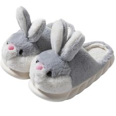 a pair of gray and white slippers with bunny ears