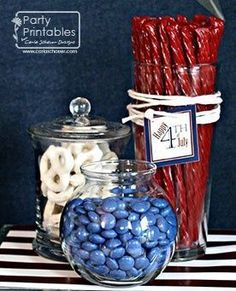 candy bar with red, white and blue candies in glass containers on striped tablecloth