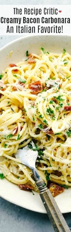 a white plate topped with pasta covered in sauce