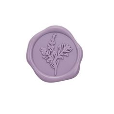 a wax stamp with a flower design on the front and back of it, in purple