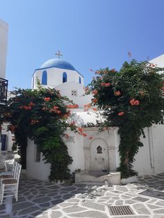 a white building with blue domes and flowers on it