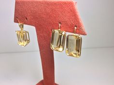 "This stunningly beautiful set came from an estate. Not often do you find this carat size in a natural golden yellow topaz. They are cut very well and the clarity of the stones is very good . Nothing to hide with the minimal style settings-shows these amazing stones off perfectly! The shepherds hook earring style is so comfortable. Pendant does not come with a chain,the bale is made large enough to accommodate any number of different chains. Pendant 10 x 14mm approximate carat weight 10, length Yellow Topaz Jewelry With Brilliant Cut, Yellow Topaz Necklace, Fine Jewelry Yellow Topaz, Vintage Yellow Pendant Jewelry, Topaz Earrings Yellow, Shepherds Hook, Topaz Pendant, Minimal Style, Golden Yellow