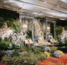 an elaborately decorated room with chairs and flowers