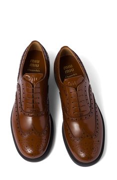 Featured in Miu Miu's fall '23 runway show, this wingtip oxford with classic broguing was created in collaboration with the storied British footwear maker. 1 3/4" (44mm) heel; 1" platform (size 38.5) Lace-up style Leather upper and lining/rubber sole Made in Italy Designer Shoes Luxury Chic Oxfords With Brogue Detailing, Double Monk Strap Shoes, Gents Shoes, Oxford Platform Shoes, Oxford Brogues, Monk Strap Shoes, Miu Miu Shoes, Leather Brogues, Wingtip Oxford