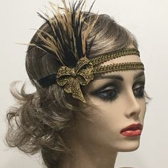 This stunning 1920's Downton Abbey vintage inspired Art Deco flapper headband is the perfect accompaniment for any styled event. I've designed and created this of a kind headband so feminine and romantic. Made with two rows of a black and gold woven trim backed with satin elastic. This headpiece features black and antique gold Ostrich feathers embellished with a Vintage Inspired Antique Brass Bow brooch with Gold Rhinestones.  I have designed and created each piece from my smoke-free studio. All pieces are securely wrapped and boxed to prevent damage/breakage. Ready to ship.  Feel free to convo me if you have any questions. Thank you very much for visiting my shop. Have a blooming day! 1920s Hair Accessories, 1920s Headband, Gatsby Headband, 1920s Headpiece, 1920s Hair, Flapper Headband, Vintage Inspired Art, Bow Brooch, Ostrich Feathers