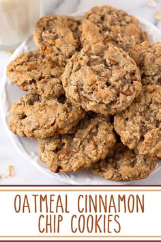 oatmeal cinnamon chip cookies on a white plate next to a glass of milk