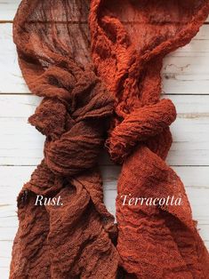 two scarves with the names rust, terracotta and rutu on them