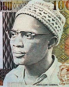 an african man wearing glasses and a turban on top of a ten dollar bill