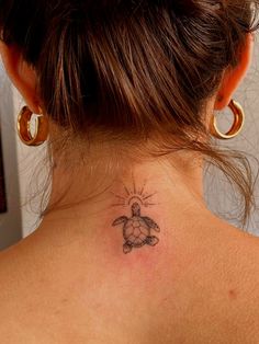 a woman with a turtle tattoo on her neck