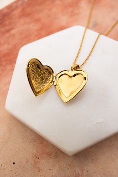 The Love Me Heart Heart Locket Necklace is the perfect way to show someone you care. Available in gold and silver, this cute necklace is a perfect gift for any occasion. Spread love and happiness with this adorable accessory. #lovemyleto #completeyourlook 100% Stainless Steel Imported Dainty Heart Pendant Locket Necklace With Charm, Dainty Heart Locket Necklace With Charm, Heart Cut Locket Necklace For Valentine's Day, Elegant Heart Locket Charm Necklace, Elegant Heart Locket Necklace With Adjustable Chain, Elegant Heart Locket Necklace For Mother's Day, Dainty Open Heart Locket Necklace With Heart Charm, Elegant Heart Shaped Locket Charm Necklace, Elegant Heart Shaped Locket Necklace For Mother's Day