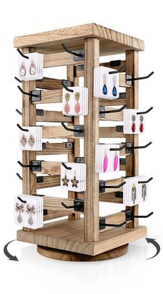 a wooden display case with earrings on it's sides and earring holders in the middle