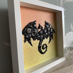 a shadow frame with buttons in the shape of a bat