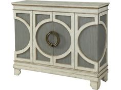 a white and grey cabinet with an oval design on the front, two doors at the bottom