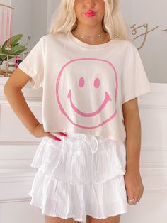 Add a smile to your wardrobe with the Simply Smiley Tee from Sassy Shortcake - This neutral cropped tee puts a pink smiley face front and center. She is paired here with our flirtatious white linen skirt. fit: true to size, model wearing a size small. care: hand wash cold Preppy Shirts For School, Cute Preppy Clothes, Preppy Back To School Outfits, Preppy Shirts, Sassy Shortcake, Pink Smiley Face, White Linen Skirt, Pink Smiley, Preppy Fits