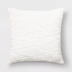 a white pillow sitting on top of a table