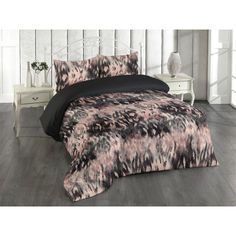 an image of a bedroom setting with black and pink bedding