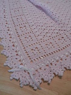 a crocheted blanket is laying on the floor