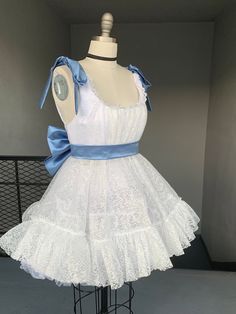 The Marie Dress is a gorgeous, handmade in LA tea dress custom made to your measurements. It's orginal colors are white and powered blue, but the colors can be interchanged to your preference. The dress shown in the photos has a petticoat under to create more fluffiness. Please allow 2-3 weeks for sewing and shipping. Measurements required for custom fit: Bust Underbust Overbust Waist  Strap Length  Skirt Length White Balletcore Mini Dress With Ruffles, White Ruffled Balletcore Dress, White Balletcore Dress With Ruffles, Party Organza Petticoat With Ruffles, Organza Petticoat With Ruffles For Parties, Garden Party Lace Dress With Ruffles, Ruffled Lace Dress For Garden Party, White Tiered Organza Dresses, Delicate Lace Mini Dress For Wedding