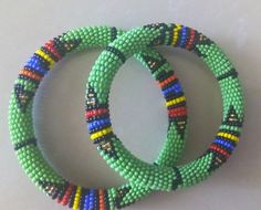 Beaded Bracelets | African Maasai Beaded Bracelets | African Jewelry | Zulu Beaded Bracelets | Ethnic Bracelets | Gift For Her | A Set Of Two These superbly crafted Zulu beaded bracelets are made of fine beads.The price is for a set of two bracelets.Main Color - Green.Size - Standard measurement is 7 - 8 inches.For smaller or larger bracelets please contact me.Available in different colors.Feel free to send me a convo or e-mail for any clarification.Thank you for visiting... Green Bangle Friendship Bracelets, Traditional Green Friendship Bracelets, Artisan Green Beaded Bracelets With Round Beads, Bohemian Handmade Bangle With Round Beads, Artisan Green Beaded Bracelets, Bohemian Bangle With Colorful Beads, Handmade Bohemian Bangle With Round Beads, Artisan Green Bangle Bracelet, Green Bead Bracelet For Festivals