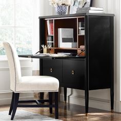 a black desk with a white chair next to it