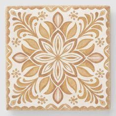 a square tile with an intricate design on it