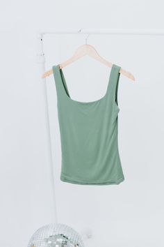 The Double Layered Reg Length Tank is a must-have for a casual summer wardrobe, offering the best basics with its double-layered design that adds a touch of uniqueness to a cute and solid shirt. This stylish and lightweight tank effortlessly embodies a summer aesthetic. Double Layered Tee Fixed straps Premium ribbed knit fabrication Fit: Fitted; Generous stretch Fabric: 92% Nylon 8% Spandex Model Specs: Emily + Karli are wearing a size small in the photo.How will this item fit you? Check out our Versatile Tank Top For Summer Loungewear, Green Seamless Scoop Neck Tops, Casual Green Solid Color Tank Top, Everyday Tops For Spring, Summer Stretch Tops With Seamless Design, Seamless Stretch Summer Tops, Summer Stretch Seamless Tops, Versatile Green Stretch Tops, Solid Color Summer Tops For Day Out