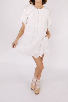 This white embroidered floral mini dress is the epitome of romantic elegance. Featuring a delicate scallop hemline and ruffle lace details, it is the perfect addition to any summer wardrobe. Enhance your feminine charm and steal hearts wherever you go with this beautiful dress. Details Round neckline Keyhole closure Ruffle lace details Embroidered fabricaiton Scallop hemline Lined Pockets Sizing Approximate measurements: SIZE LENGTH BUST WAIST Small 33” 36” 36” Medium 33” 38” 38” Large 34” 40” 40” Fabric has no stretch Model is 5’8” wearing small Material Self: 85% Tencel 15% NylonLining: 97% Polyester 3% Spandex Hand wash cold cold Do not bleachLay flat to dryFor best results dry clean Summer Brunch Dresses With Scalloped Edges, Summer Crochet Dress With Lace Trim, Mini Length, Flowy Lace Dresses With Floral Embroidery, Summer Flowy Scalloped Lace Dress, Flowy Scalloped Lace Dress For Summer, Flowy Scalloped Lace Summer Dress, Spring Mini Crochet Dress For Brunch, Spring Crochet Mini Dress With Lace Trim, Spring Crochet Dress With Lace Trim