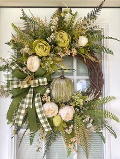 a wreath is hanging on the front door