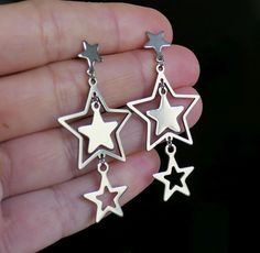 "Stainless steel star charm and star stud earrings. These earrings are made of stainless steel only. Earring length: 52mm, 2\" Charm material: stainless steel Earring stud material: stainless steel Backs: rubber This listing is for 1 pair of stainless steel star charm earrings. These earrings will come in a gift bag. I offer combined shipping costs which give you a shipping discount for ordering multiple items from my shop. Please note: this item will be sent for free via standard unregistered p Star Themed Jewelry, Star Earrings Y2k, Silver Star-shaped Earrings, Punk Style Star-shaped Metal Earrings, Gothic Silver Star Earrings, Star-shaped Stainless Steel Earrings, Stainless Steel Earrings Studs, Star Stud Earrings, Earring Stud