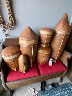 several brown baskets sitting on top of a red cushion