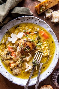 a white bowl filled with chicken and pasta soup