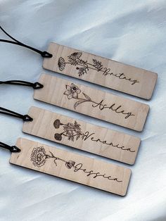 three wooden name tags with flowers on them