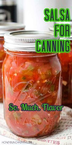 three jars filled with canned salsa sitting on top of a white tablecloth and text reads salsa for canning