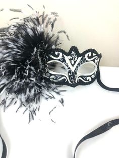 "Feather mask- NYC -Masked ball- New Years Eve- White and black Masquerade Ball- Mardi Gras -Halloween Hello, Made and ready to ship in 1-2 business days. Perfect for a masquerade party, birthday celebration, costume party, New Years Eve celebration or Mardi Gras. These feathers are on the side of a plaster mask that's black and white with some glitter. A beautiful brooch sets it all off! Made with a black sparkle tie. The feathers are about 6\" long. It's on a very comfortable mask...ages 16 an Venetian Costume Accessories For Carnival, Black Masquerade Mask For Mardi Gras Costume Party, Venetian Mask For Costume Party And Carnival, Venetian Masks For Costume Party And Carnival, Venetian Mask For Carnival Costume Party, Gothic Masks For Mardi Gras Theater, Venetian Mask For Mardi Gras Costume, Gothic Masks For Theater And Mardi Gras, Gothic Mardi Gras Costume Mask