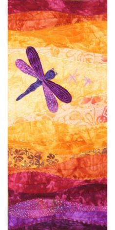 a purple dragonfly sitting on top of an orange and yellow wall hanging from a wooden fence