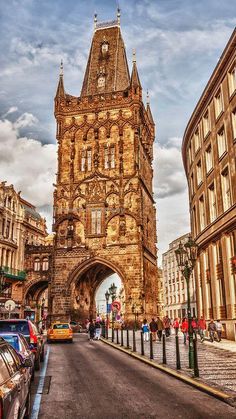 an old clock tower towering over a city street