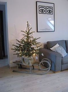 a living room with a christmas tree in the corner