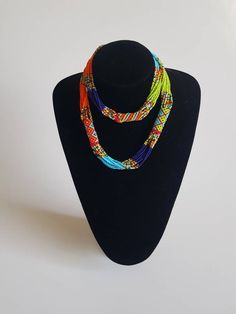 This necklace is 100% handcrafted using colorful fine beads. The necklace makes a perfect gift to loved ones. **Buy multiple items and pay shipping for 1 item only.The rest ships free. Custom orders are welcome. More neckleces here; https://www.etsy.com/shop/TribalTess?ref=seller-platform-mcnav&section_id=21306083 Back to my shop; https://www.etsy.com/shop/TribalTess?ref=seller-platform-mcnav Traditional Colorful Beaded Necklaces As Gift, Unique Multicolor Beaded Chain Necklaces, Unique Multicolor Beaded Necklaces, Rainbow Multi-strand Necklace As Gift, Rainbow Multi-strand Necklace For Gift, Unique Multicolor Beaded Necklace, Rainbow Multi-strand Necklace Gift, Unique Orange Beaded Necklace With Colorful Beads, Vibrant Rainbow Beaded Necklace As Gift